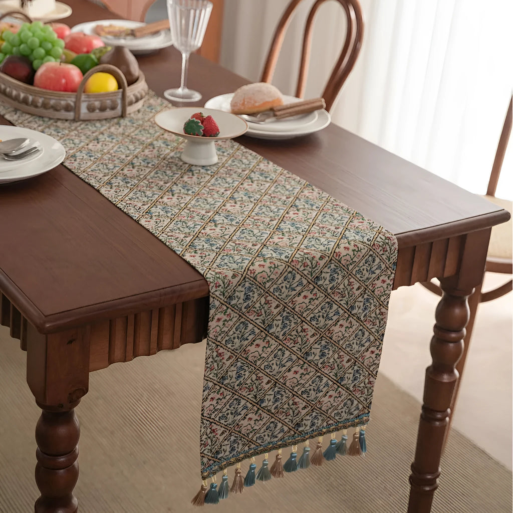 Dark blue striped table runner with fringed tassel trim laid on dining table