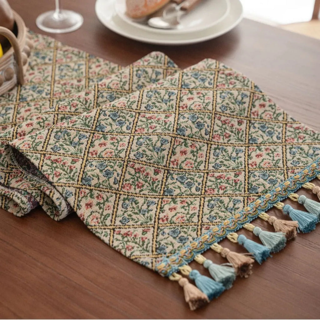 Dark blue striped table runner with fringed tassel trim laid on dining table