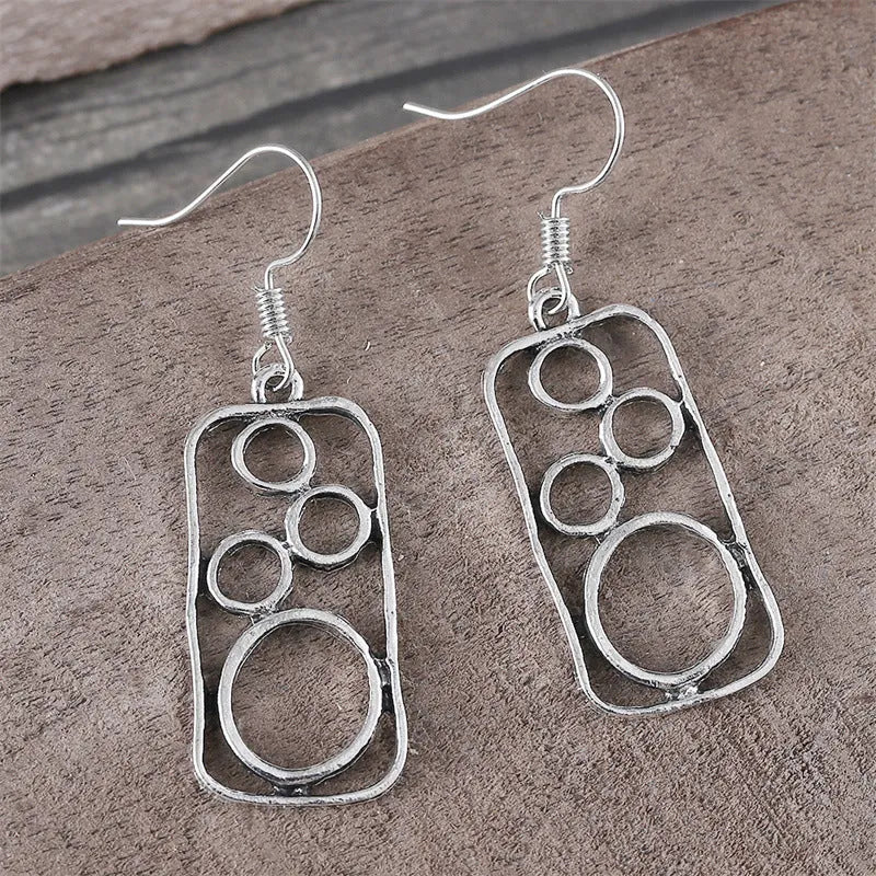 Geometric ring earrings in antique silver colour with irregular square and round shapes
