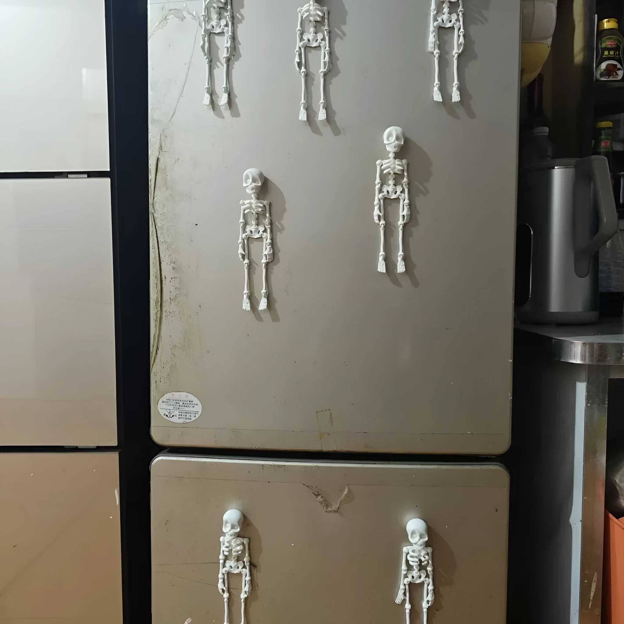 3D printed Halloween skull ornament in multiple colours displayed as fridge magnet
