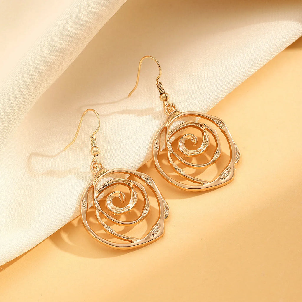 Spiral donut jewellery set showing necklace, bracelet and earrings in gold tone geometric circle design