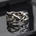 Copper men's ring with geometric thorn flower design and adjustable band in J2150 colour.