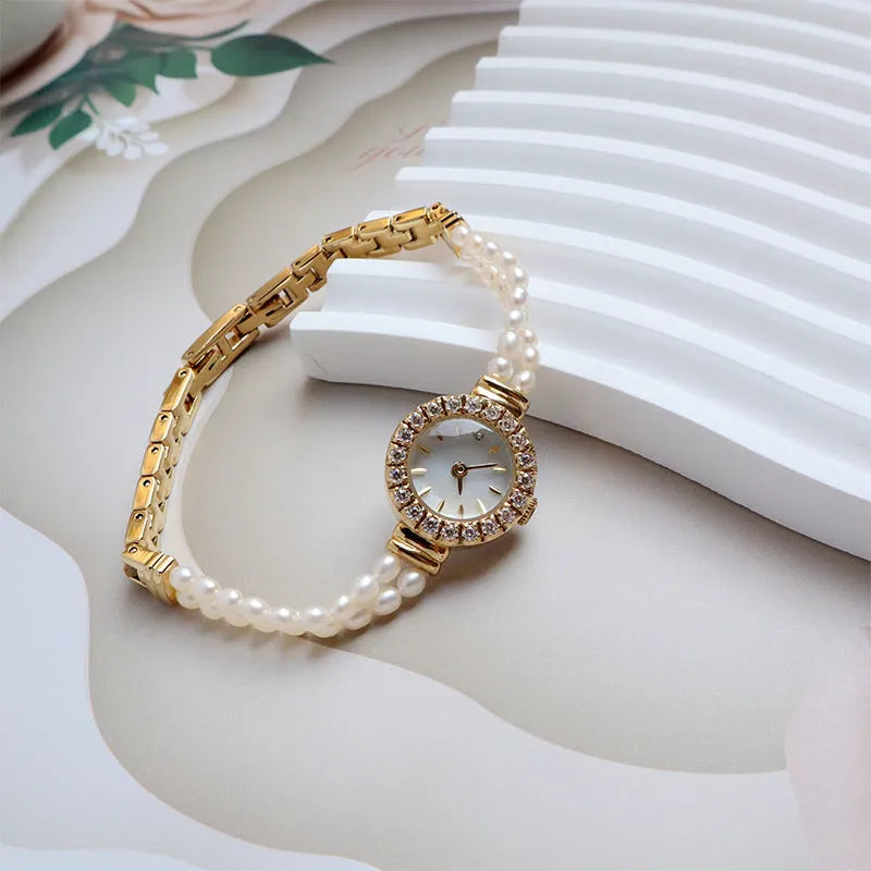 Women's light gold freshwater pearl bracelet watch with round dial on stainless steel strap