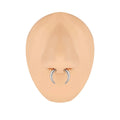 Black and steel coloured C-shaped nose ring with a buffalo horn centre on a grey background