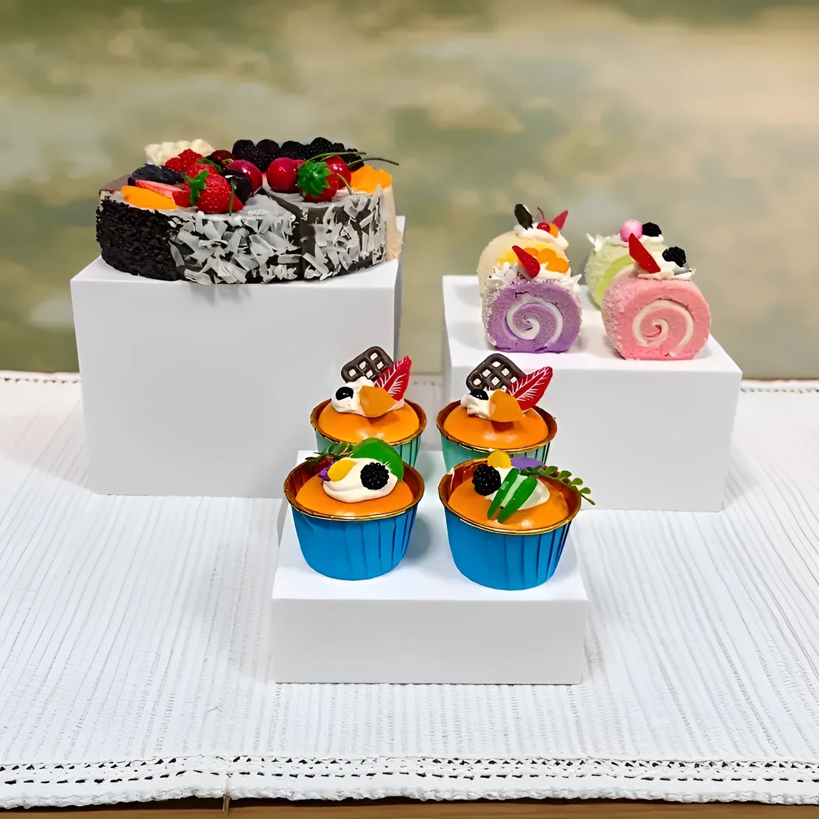 White plastic modular cube dessert display stand with six stackable units for cakes and pastries