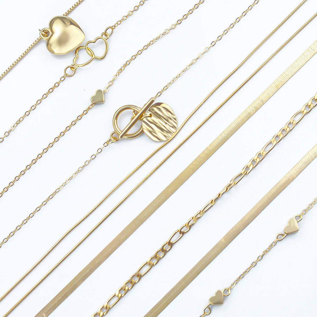 Ten gold-coloured women's necklaces with different alloy pendants on snake bone chains