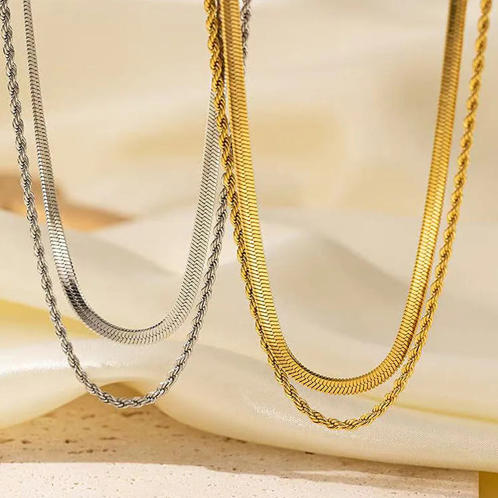 Women's double-layer twist necklace with geometric titanium steel pendant on an adjustable snake bone chain.