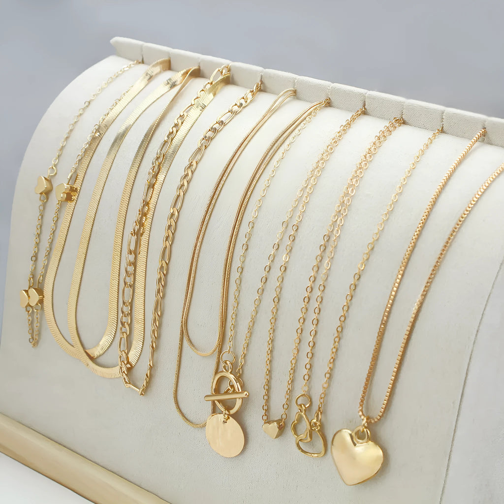 Ten gold-coloured women's necklaces with different alloy pendants on snake bone chains