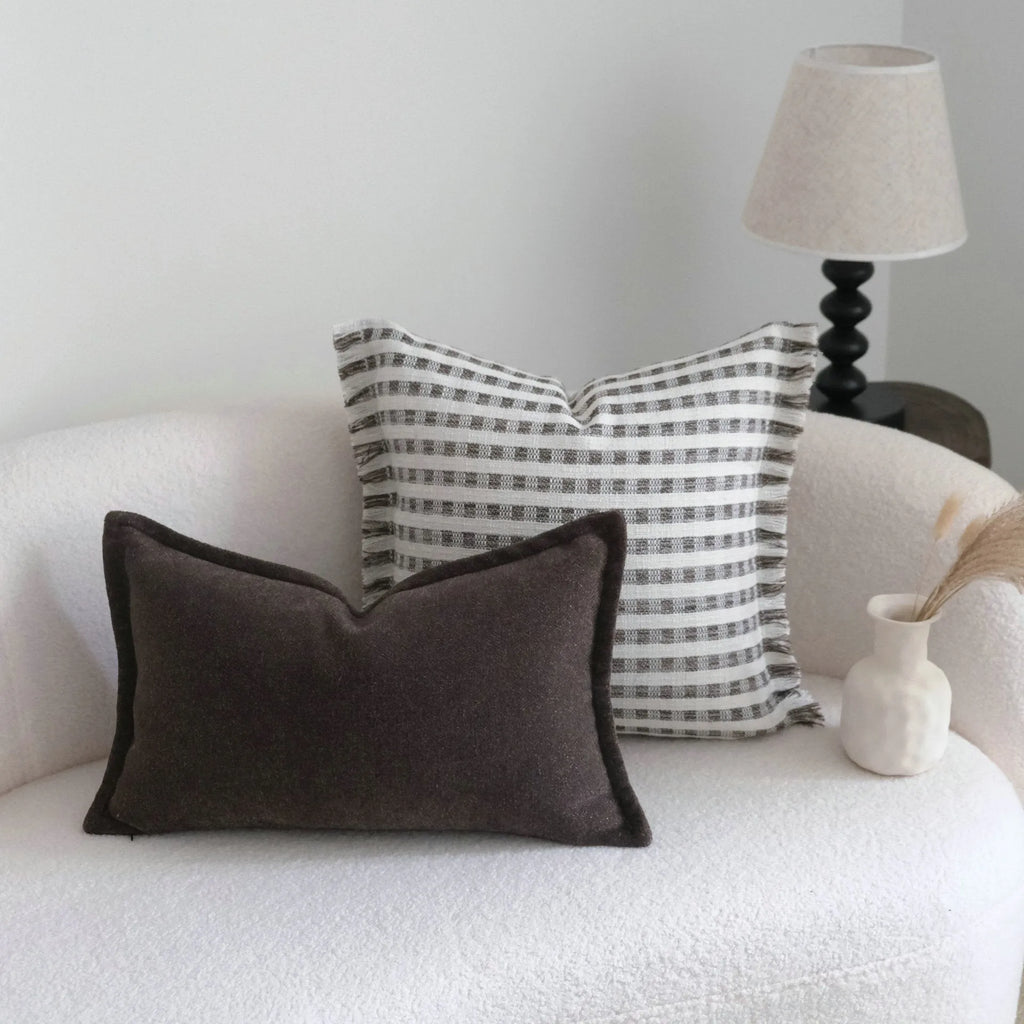 Coffee brown striped mid-ancient Chinese style decorative pillow cushion on a sofa.
