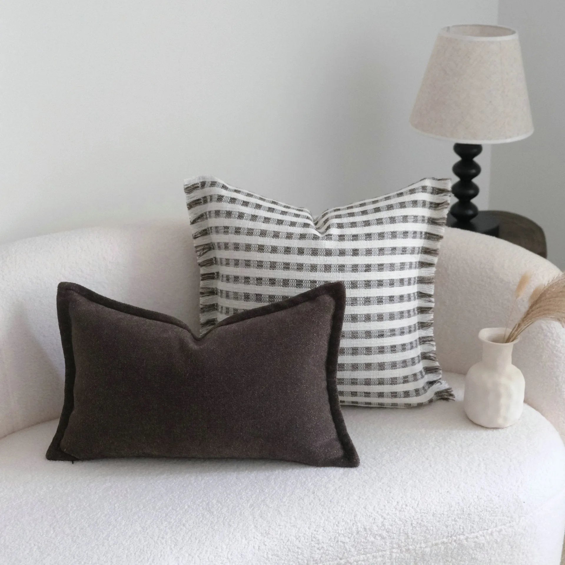Coffee brown striped mid-ancient Chinese style decorative pillow cushion on a sofa.