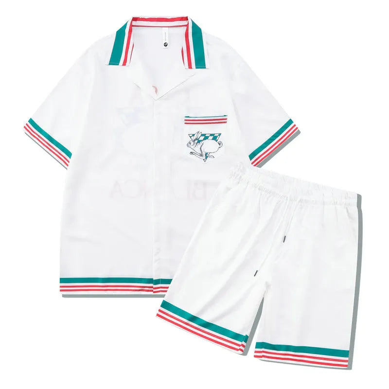 Plaid print beach outfit set for men and women, featuring a short sleeve shirt and matching trousers on a hanger.