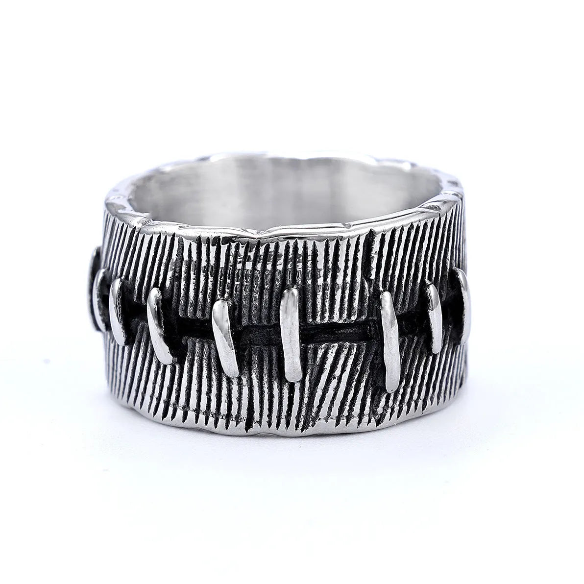 Geometric dark punk double ring in titanium steel on a black background, showing its U-shaped silhouette.