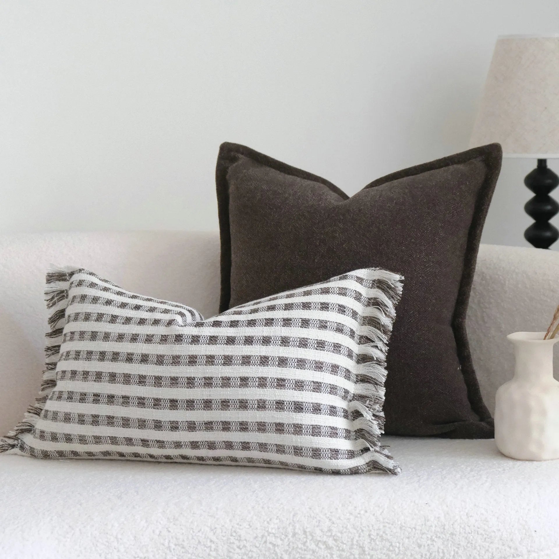 Coffee brown striped mid-ancient Chinese style decorative pillow cushion on a sofa.