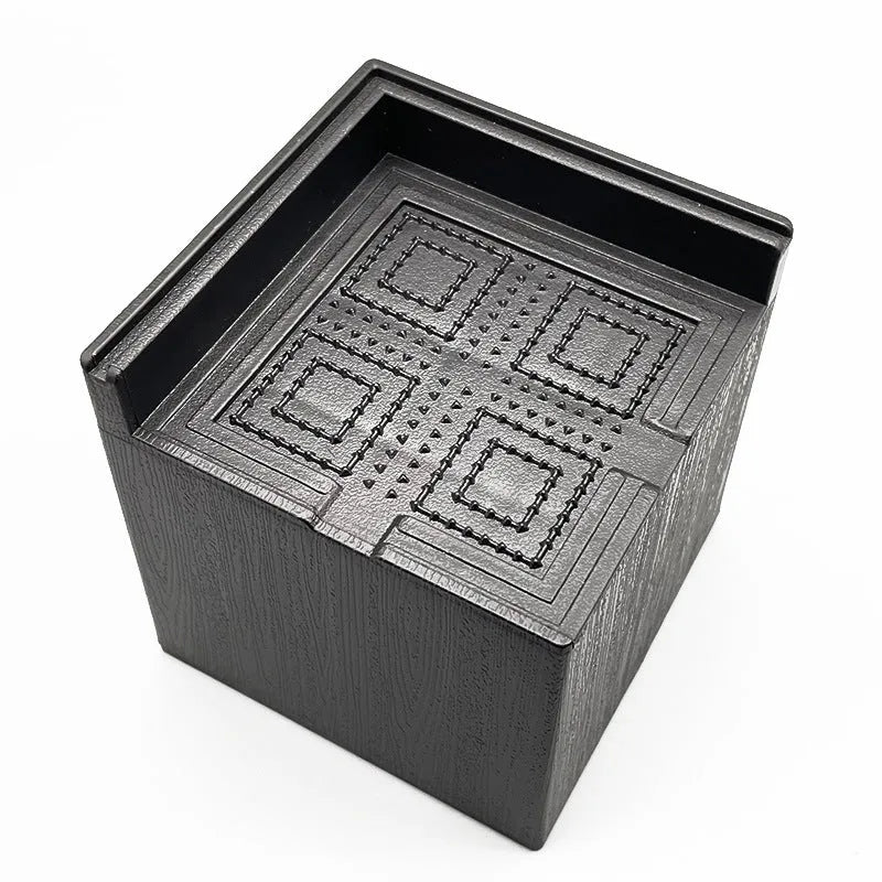 Four black plastic furniture foot mats for sofa and bed height adjustment