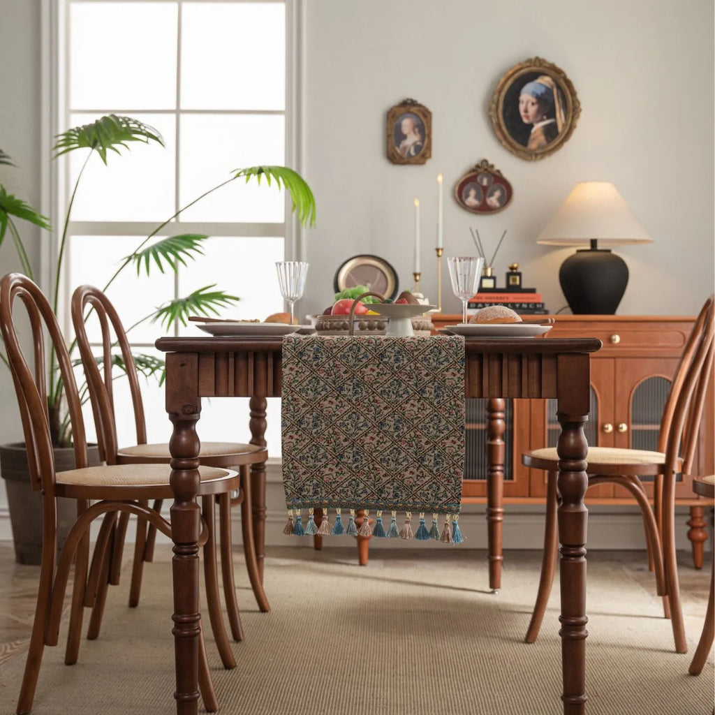 Dark blue striped table runner with fringed tassel trim laid on dining table