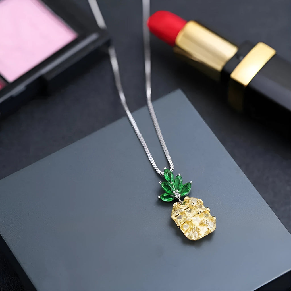 Silver geometric pineapple necklace with diamond-style stones on model
