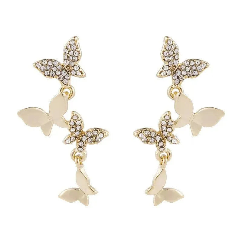 Women's gold-coloured copper earrings with four butterfly design elements in drop style