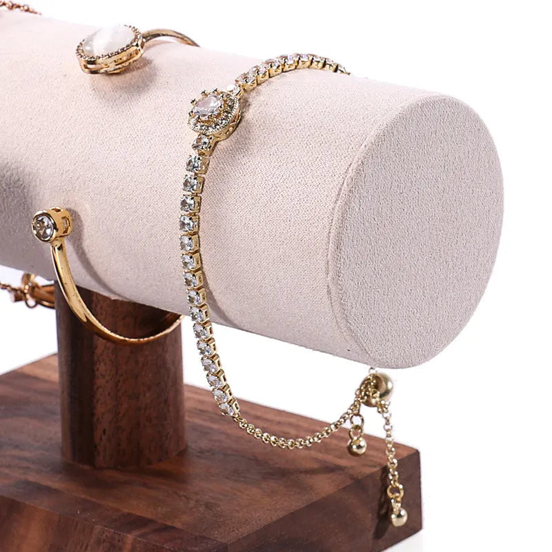 Walnut bracelet display stand with I-shaped solid wood frame and short cylinder, shown in beige velvet, dark grey, or white leather.