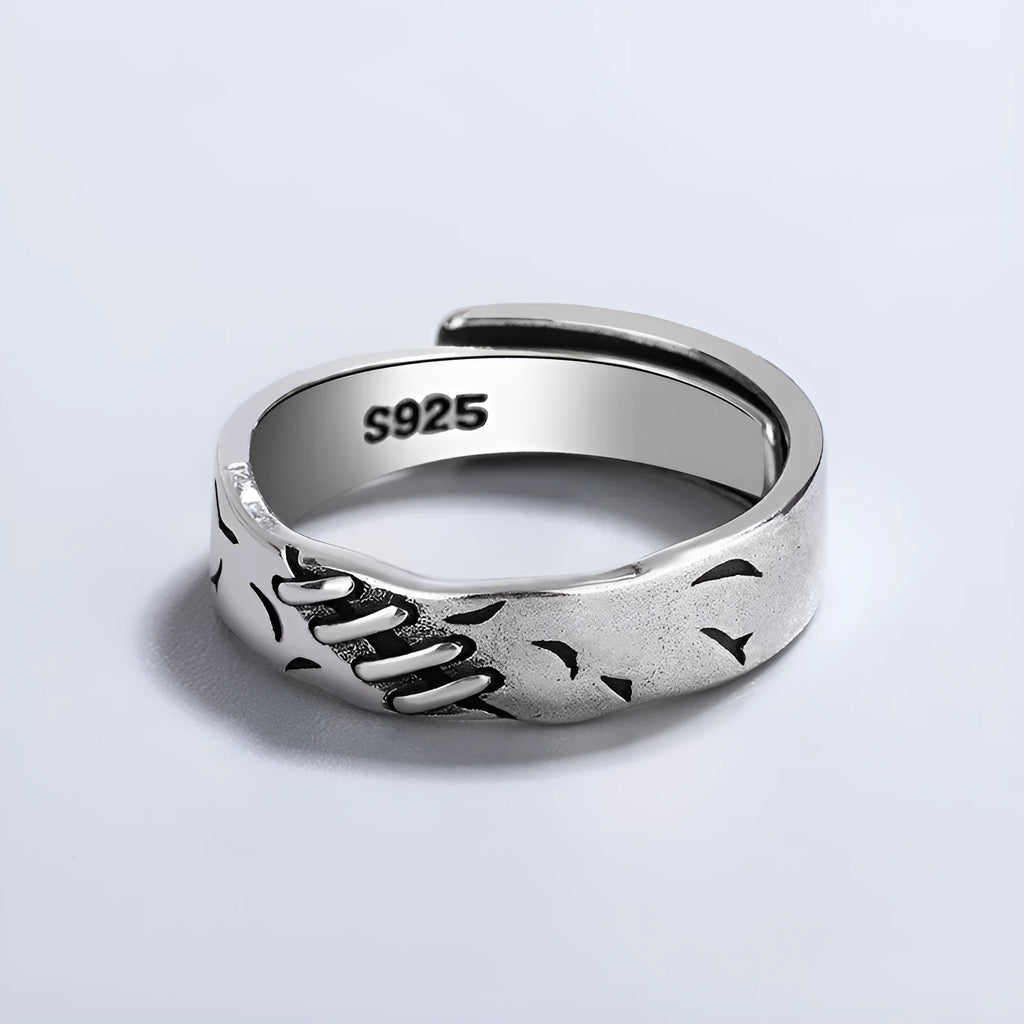 Black geometric copper ring with adjustable opening on a white background.