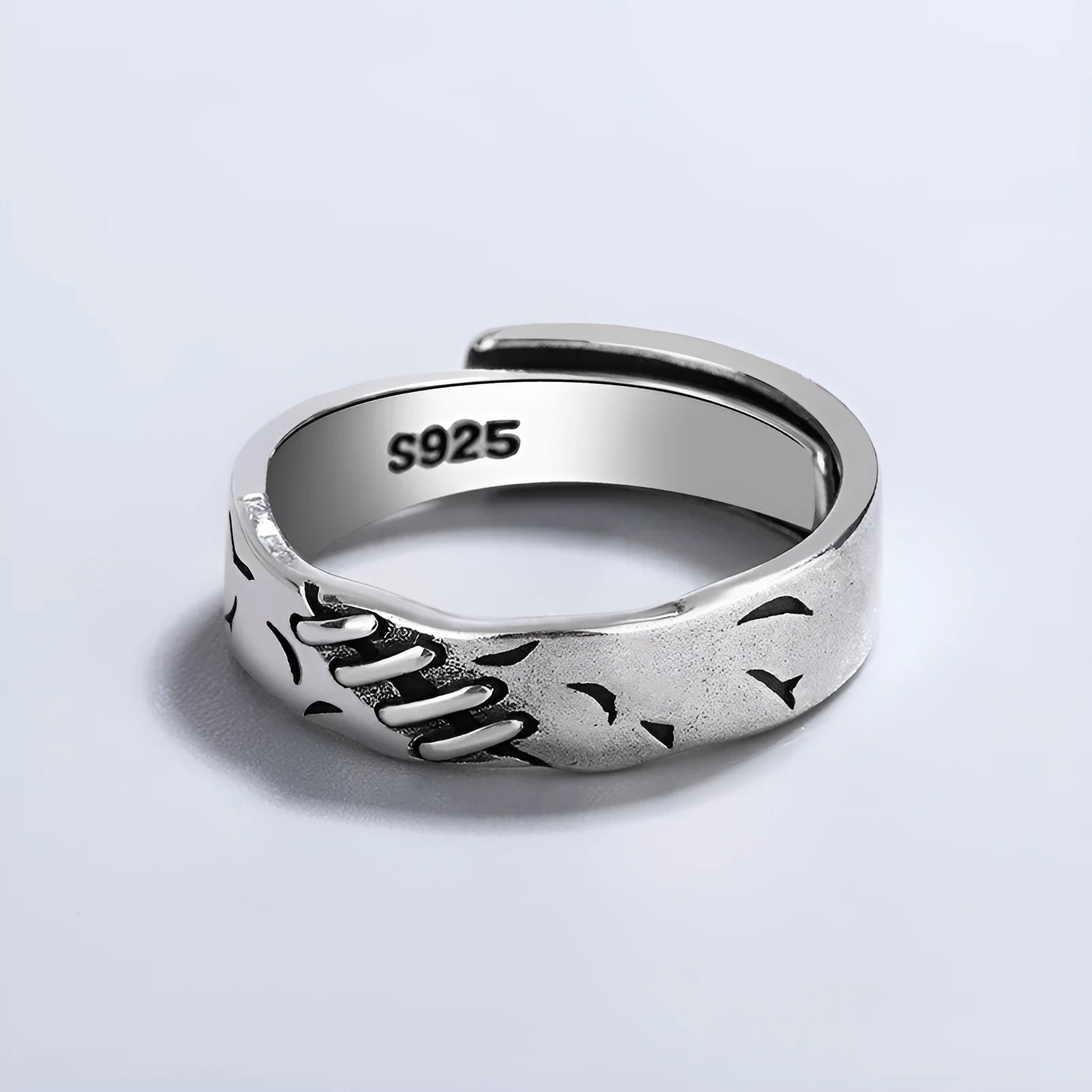 Black geometric copper ring with adjustable opening on a white background.
