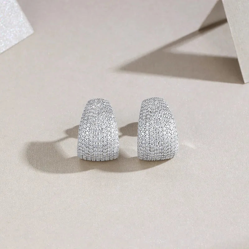 Geometric women's stud earrings in sterling silver with white moissanite stones, presented in a gift box.