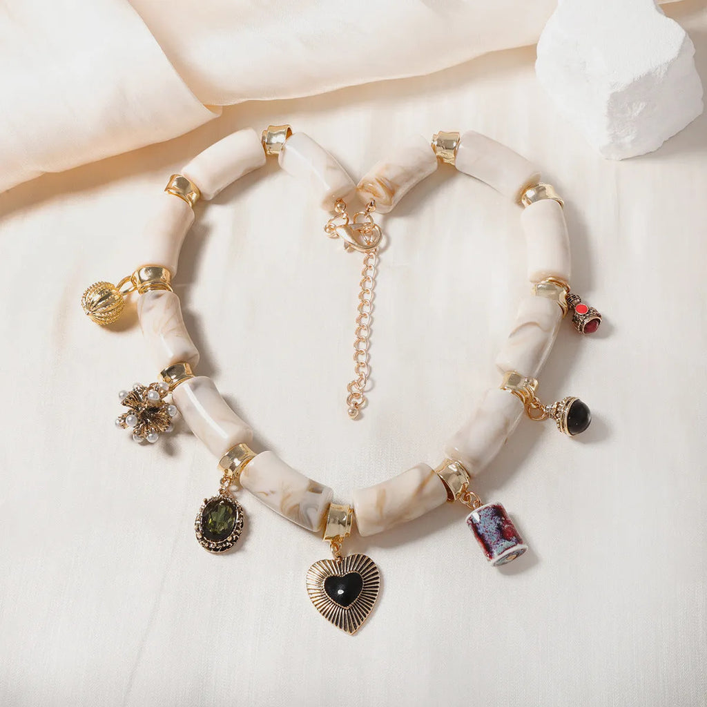 Close-up of a heart-shaped bamboo pendant necklace with electroplated finish in a picture colour.
