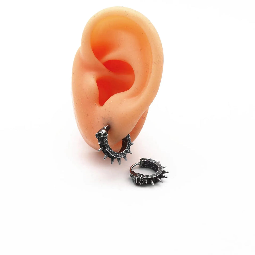 A pair of black alloy punk-style earrings shaped like geometric motorcycles.