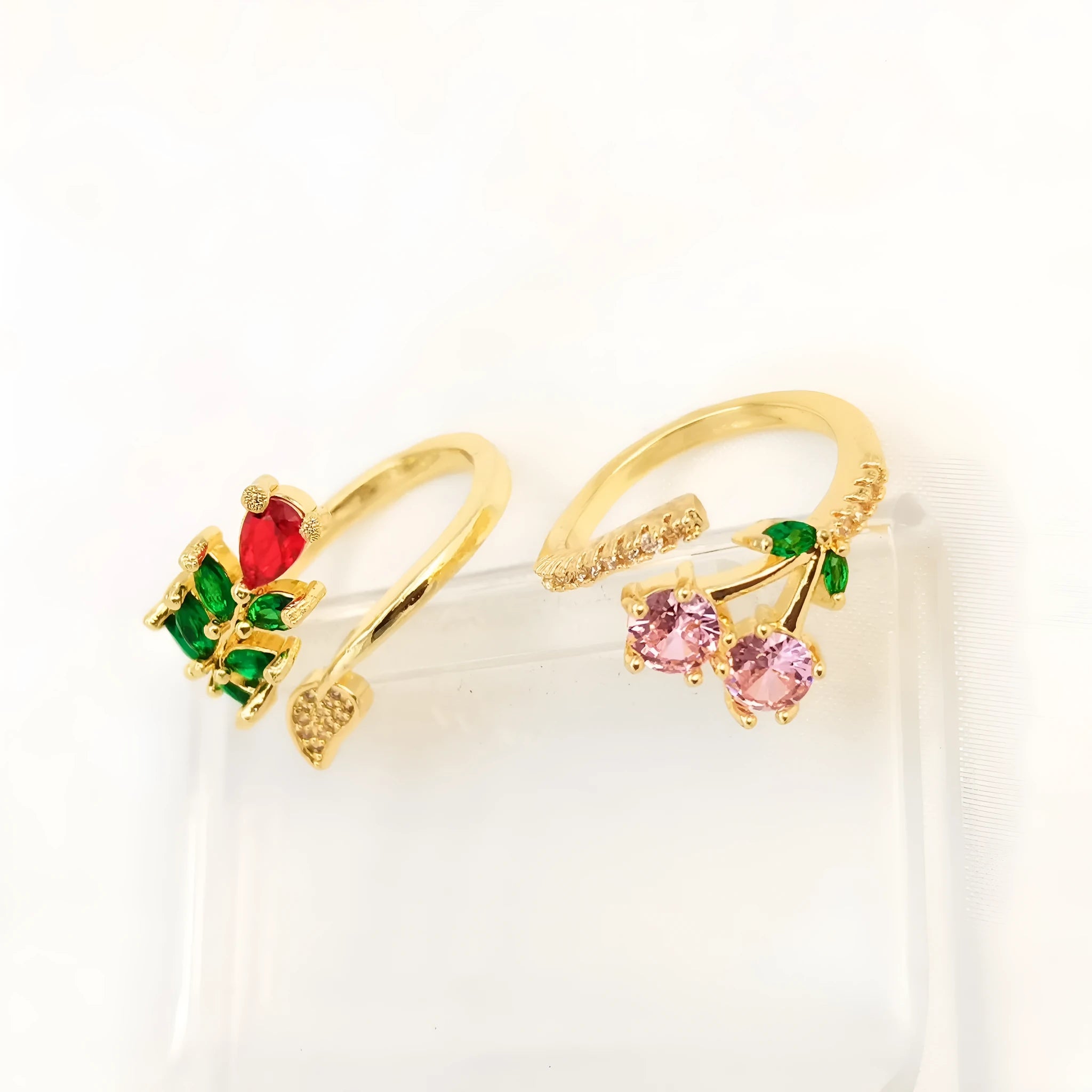 Copper geometric open ring with gold zircon plating and micro-inlaid leaf design, shown in two colours.