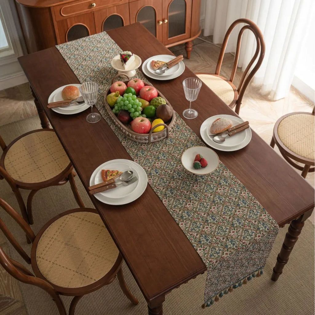 Dark blue striped table runner with fringed tassel trim laid on dining table