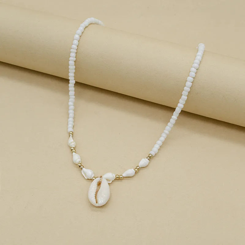 White conch shell necklace for women with a natural mother of pearl pendant on a chain.