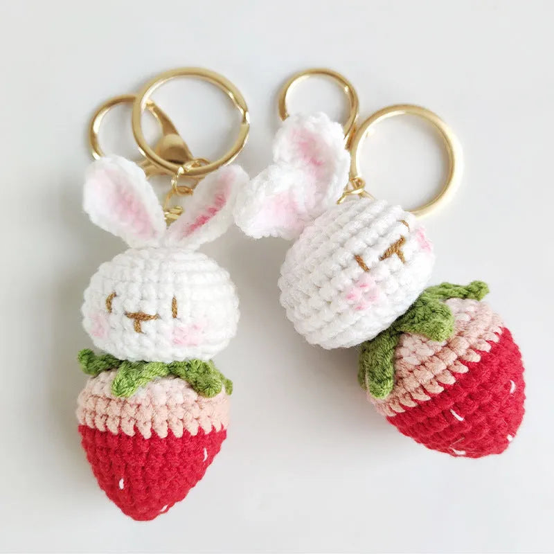 White hand-woven wire rabbit pendant with cartoon strawberry pattern and key attachment