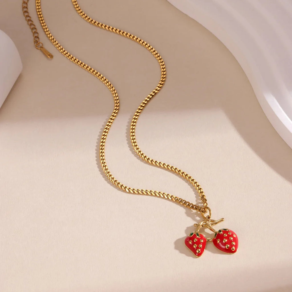 Stainless steel strawberry pendant necklace on adjustable alloy chain in red and white gradient colour options