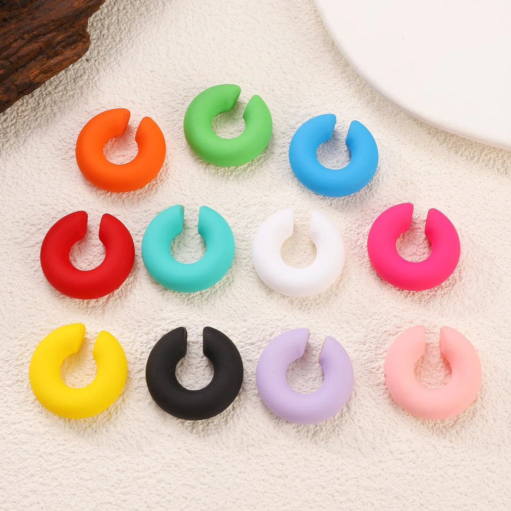 C-shaped geometric clip-on earrings with matte coarse finish in a selection of candy colours