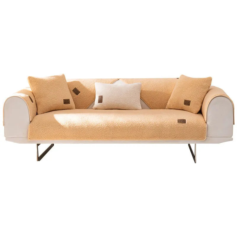 Lambswool solid colour sofa cover in blue, shown draped over a sofa arm.