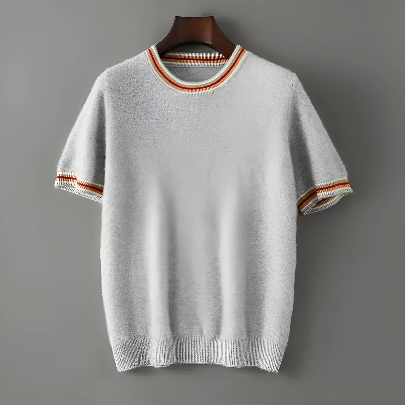 Men's short sleeve pure wool sweater in grey, showing round neck and pullover style on a middle-aged model.
