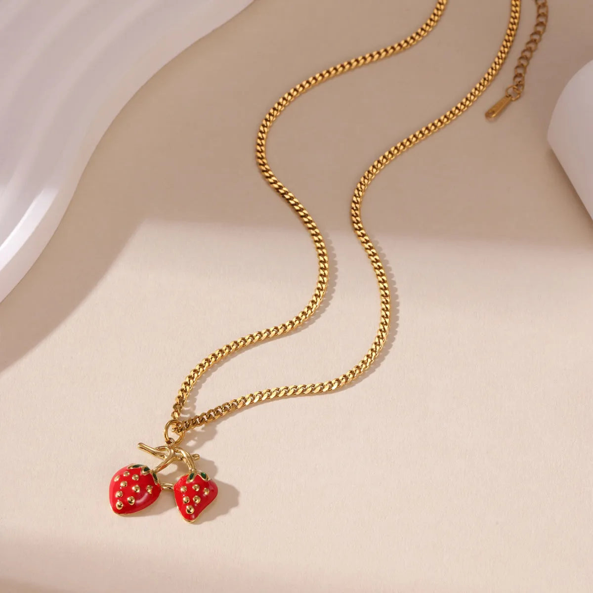 Stainless steel strawberry pendant necklace on adjustable alloy chain in red and white gradient colour options