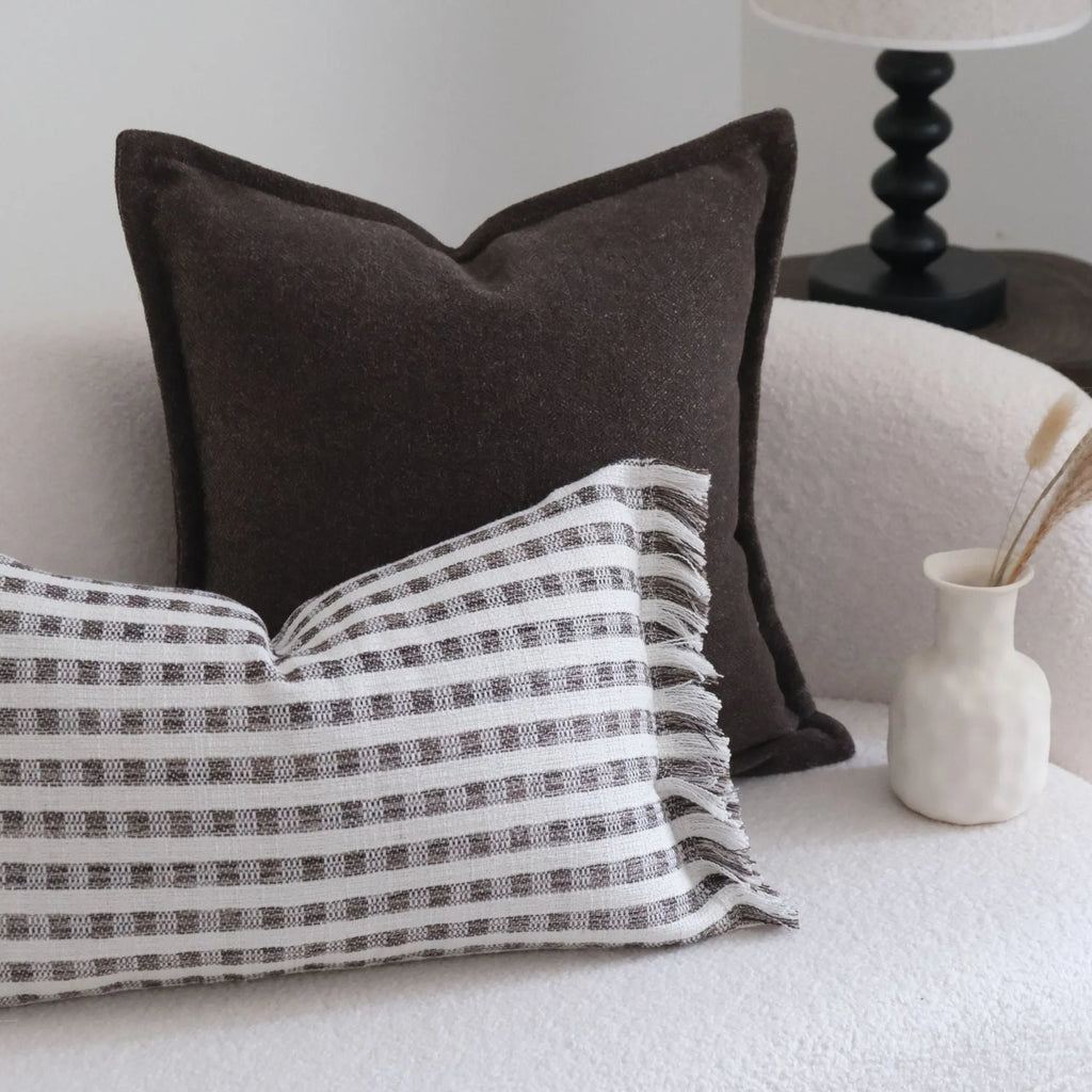 Coffee brown striped mid-ancient Chinese style decorative pillow cushion on a sofa.