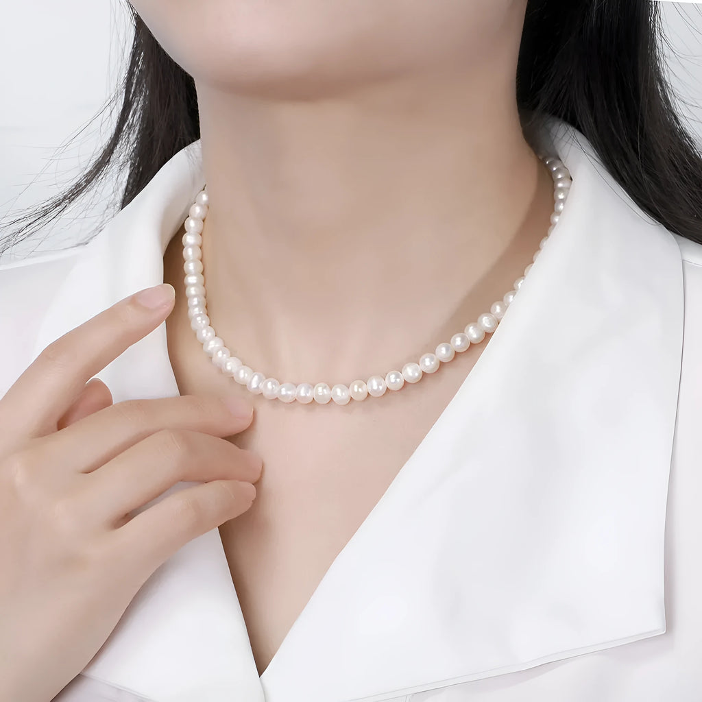 Women's adjustable sterling silver necklace with a single natural freshwater pearl.