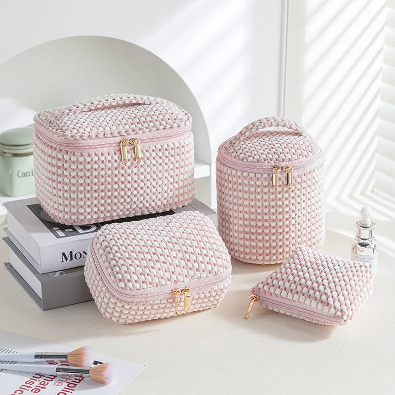 Four cube-style flannelette makeup bags in different colours: pink, khaki, pink dots, and blue with dots