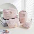 Four cube-style flannelette makeup bags in different colours: pink, khaki, pink dots, and blue with dots