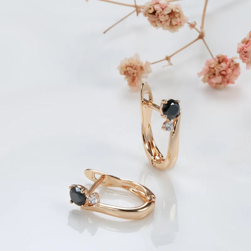 Women's gold drop earrings with black agate geometric design and clip-on back