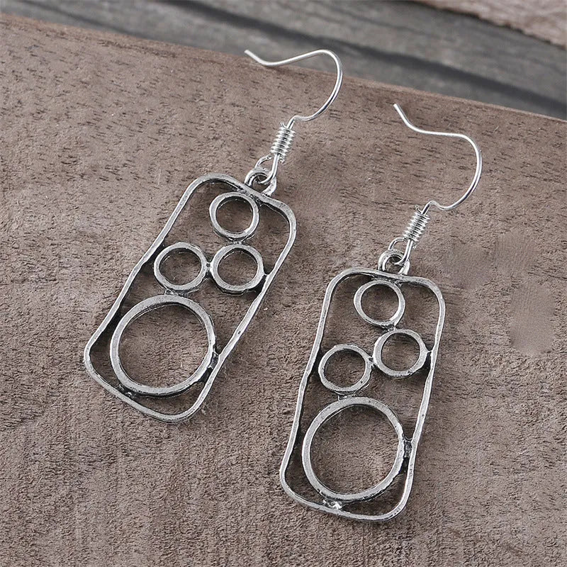Geometric ring earrings in antique silver colour with irregular square and round shapes