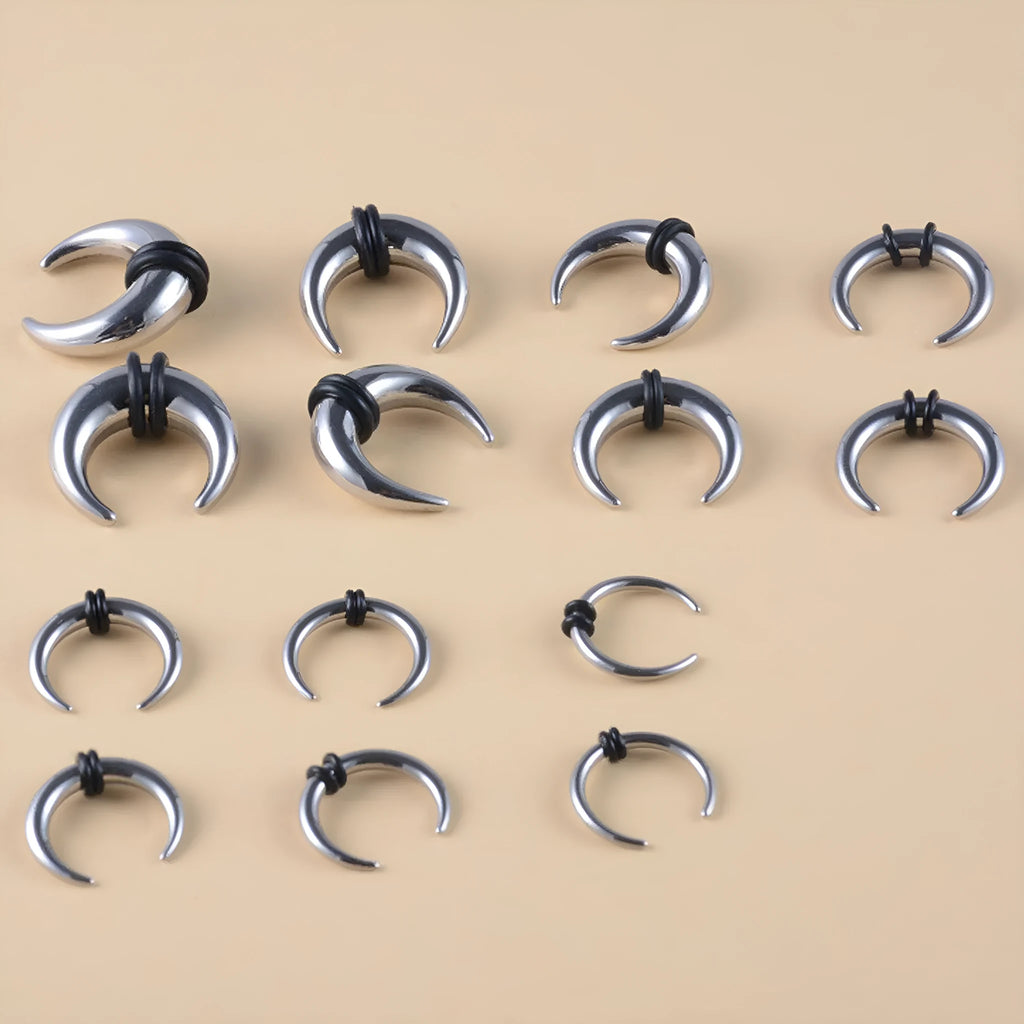 Black and steel coloured C-shaped nose ring with a buffalo horn centre on a grey background