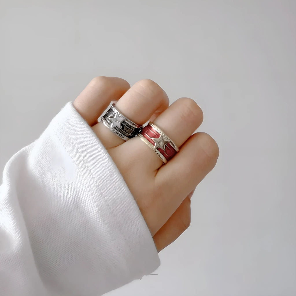 Adjustable distressed geometric ring with line design in electroplated black, blue, or red.