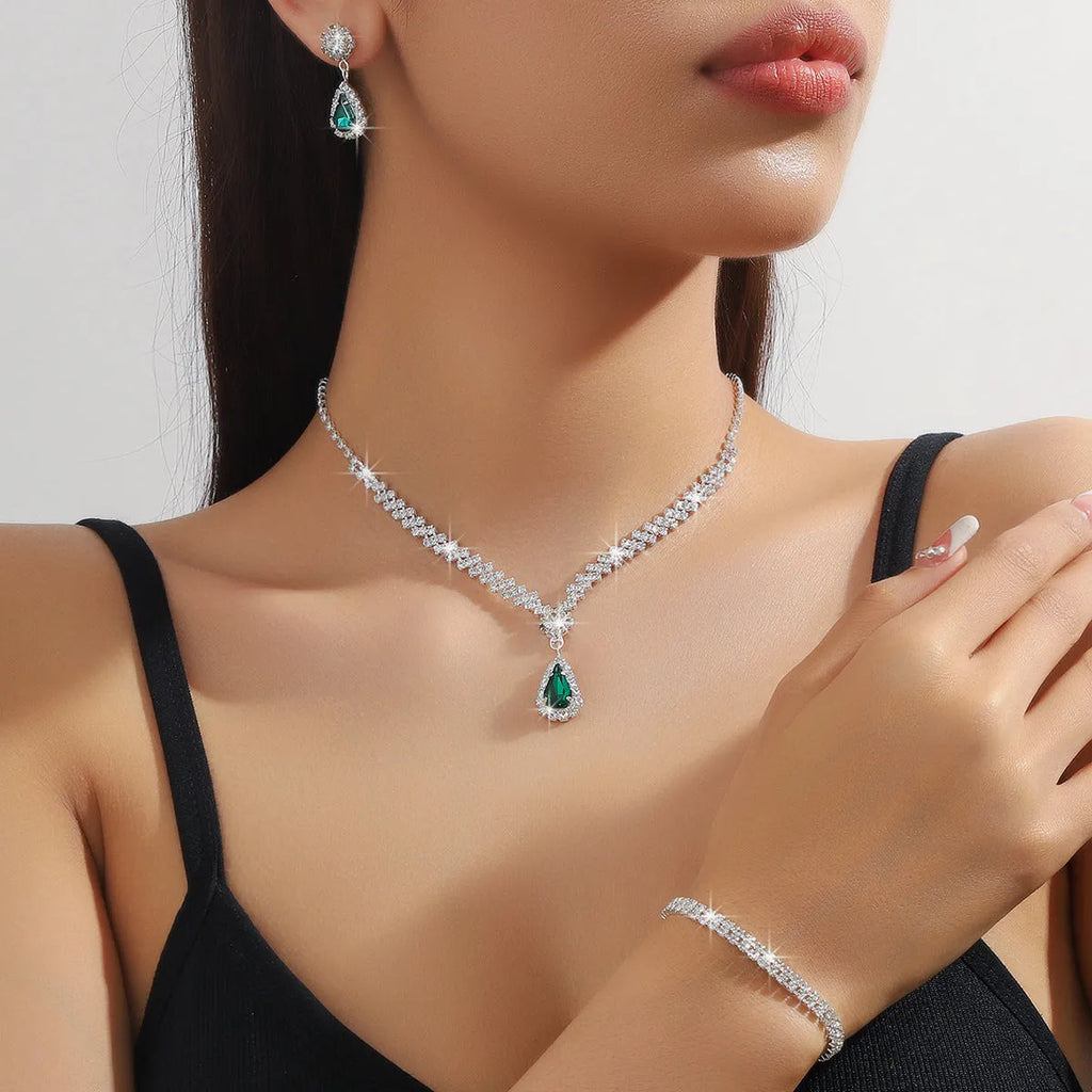 Claw chain necklace and matching earrings set with drop-shaped rhinestones in blue colour