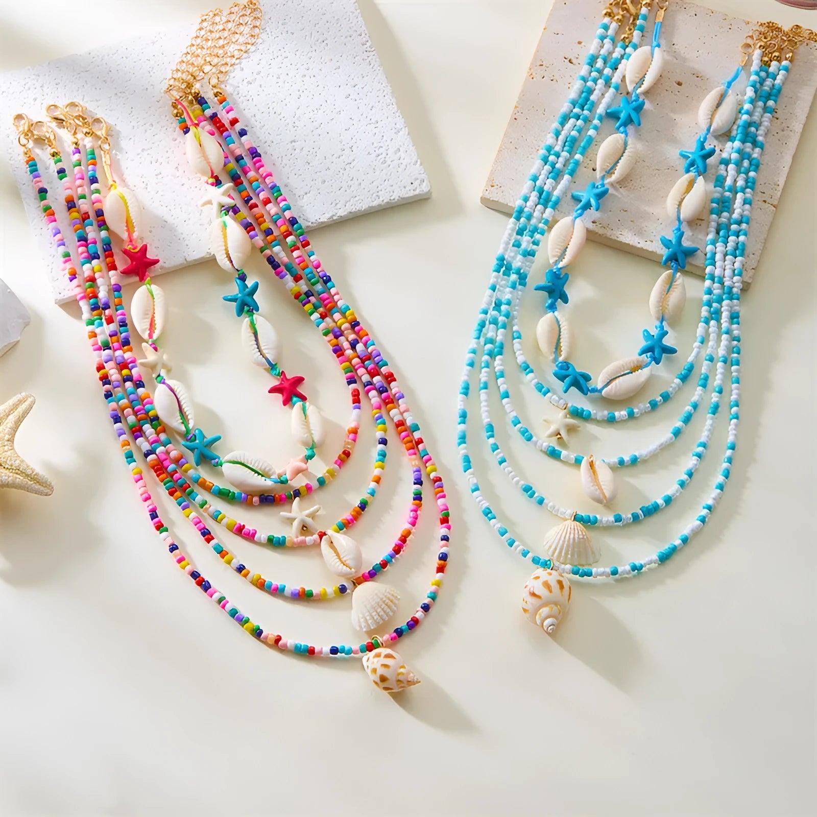 Blue and coloured multi-layer women's necklace set with starfish, shell, and conch beads on adjustable chain.