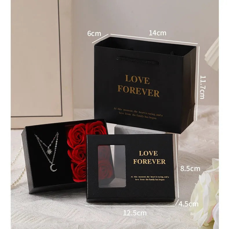 Six scented soap flowers in red pink or black inside a gift box with matching handbag