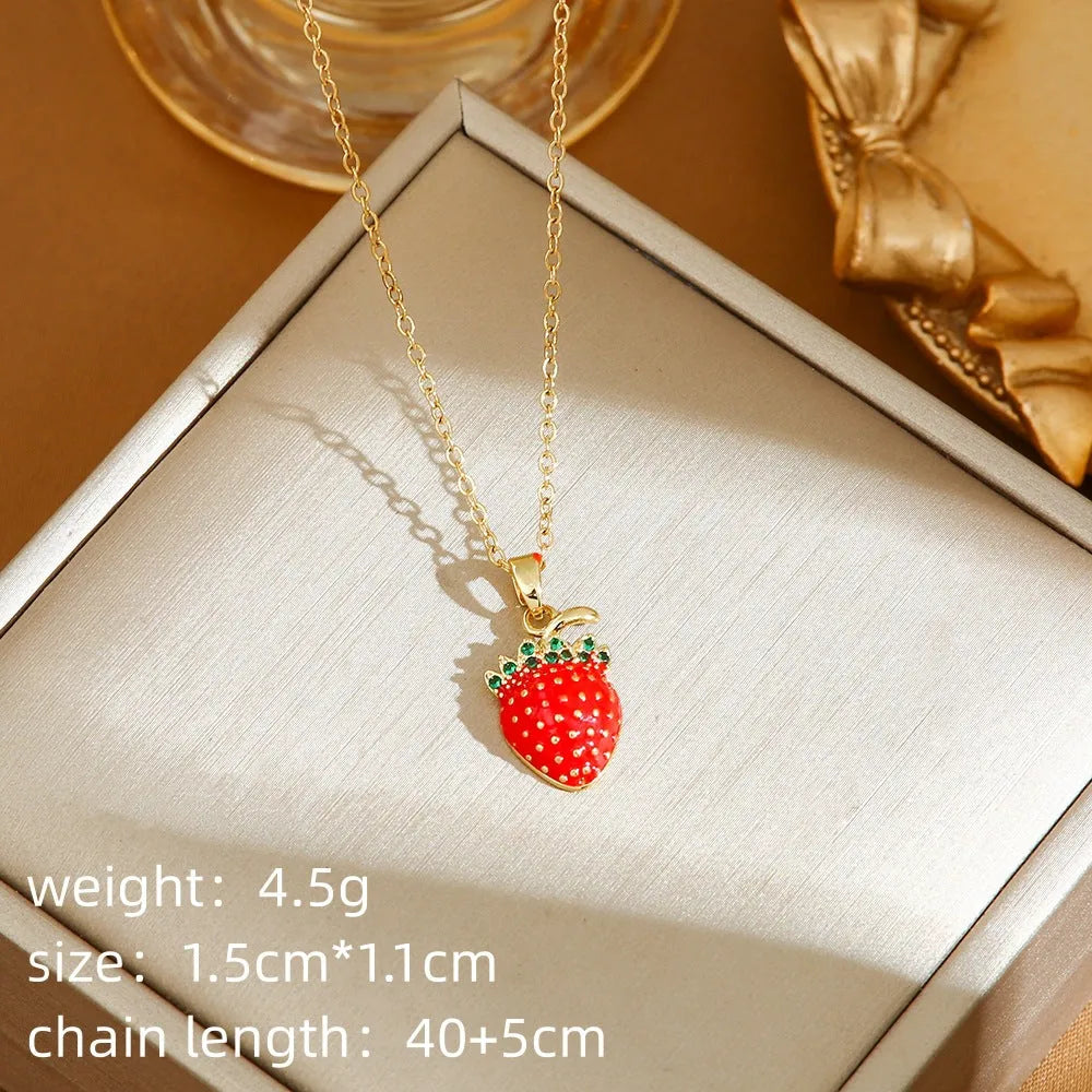 Delicate titanium steel necklace with a small cherry charm on an O-ring chain, gold finish.