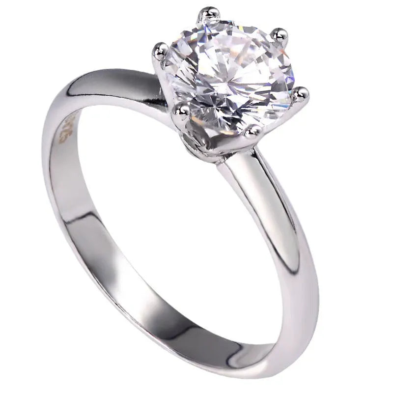Six-claw set zircon ring with geometric design and white gold plated finish on white copper
