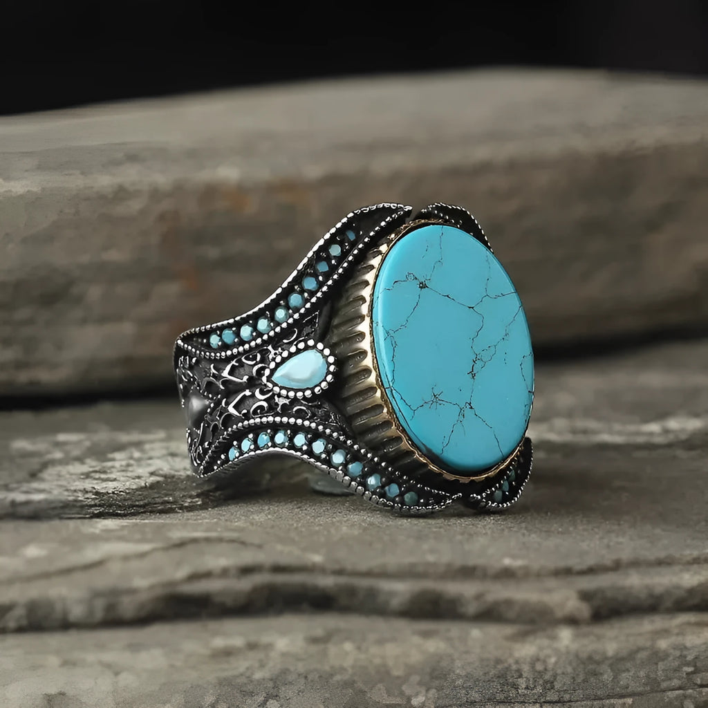 Men's antique silver round turquoise alloy ring on a plain background